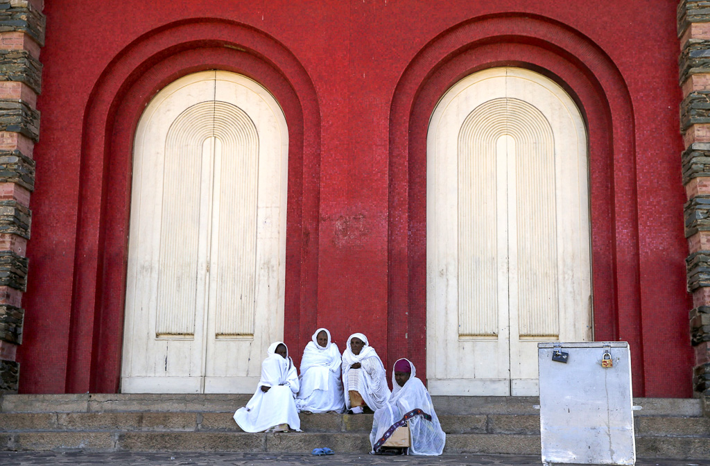 Faithful sit outside the Nda Mariam Orthodox Cathedral in Eritrea's capital Asmara, February 16, 2016. REUTERS/Thomas Mukoya