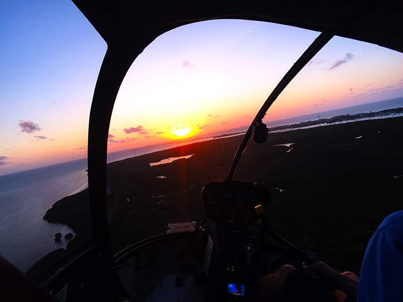 View from the helicopter cockpit at sunset