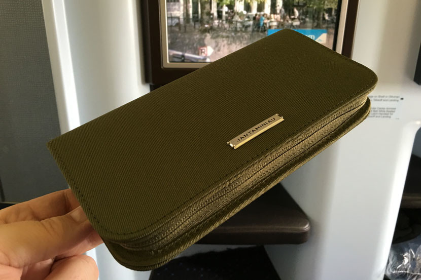 The new KLM amenity kit (green for the gents' version) is reusable as a travel wallet, but a little lacking in goodies on the inside.