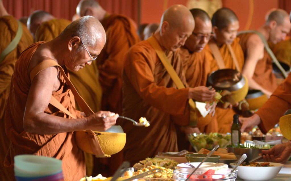 Monks receving food offerings at a monastery. Pic: Amaravati