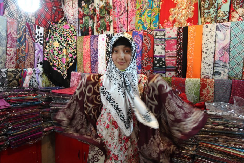 A woman selling silk shawls at the Xinjiang International Grand Bazaar. Pic: Asian Development Bank/flickr