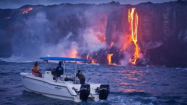 Couple watch magma from boat