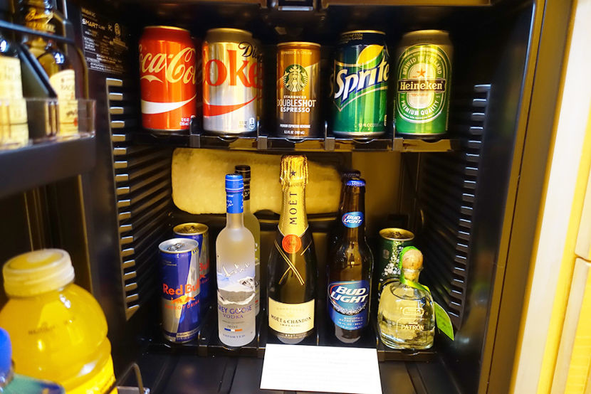 The mini-fridge was stocked with several hard and soft beverages available for purchase.