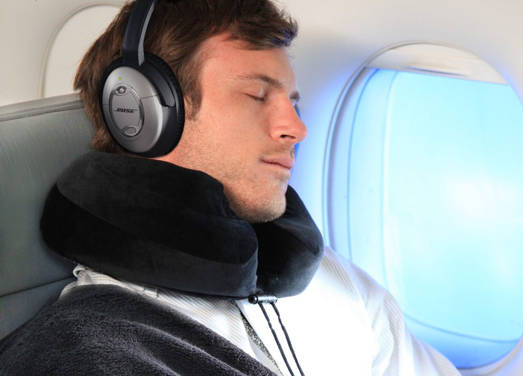 man-on-airplane-with-comfort-pillow