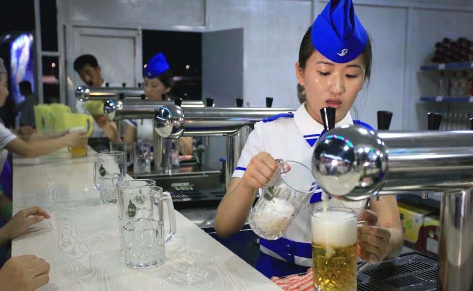 A beer server fills up glasses of draft beer at the beer festival in Pyongyang. Pic: AP