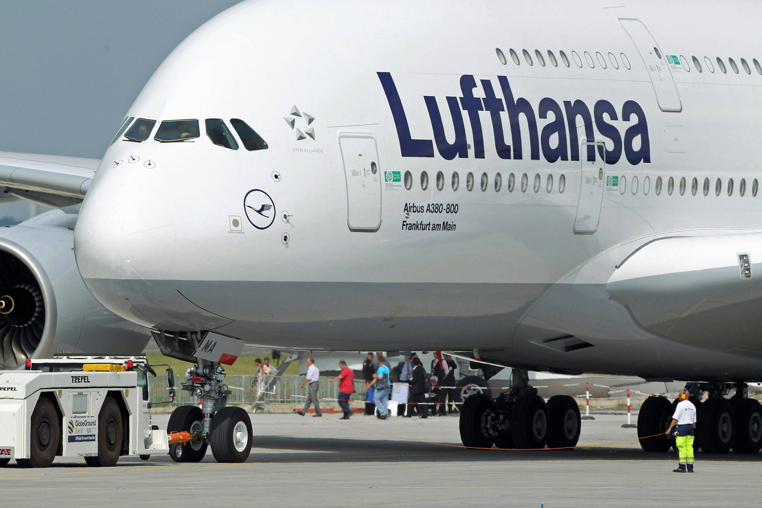 BERLIN - JUNE 08:  A groundcrew member helps guide Lufthansa Airbus A380 passenger plane before take off at the ILA Berlin Air Show on June 8, 2010 in Berlin, Germany. The 2010 ILA will run from June 8-13.  (Photo by Sean Gallup/Getty Images)