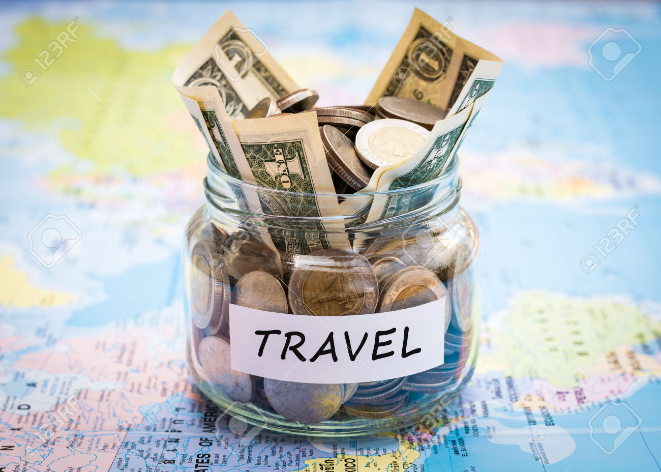 Travel budget concept. Travel money savings in a glass jar on world map