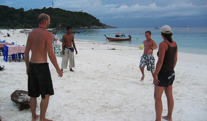 the group playing soccer on the beach in Ko Lipe