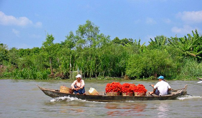 locals in boats on the Mekong River; Photo by Thomas Schoch; Wikimedia Commons