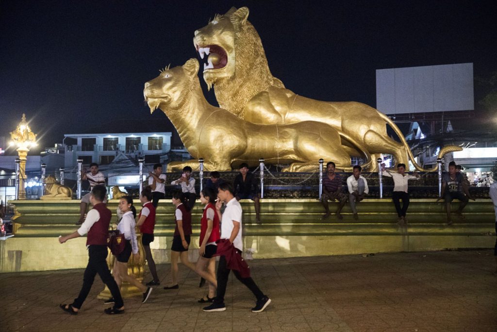 casino-workers-walk-past-the-golden-lions-roundabout.-photographer-brent-lewin-bloomberg-e1529699426185.jpg